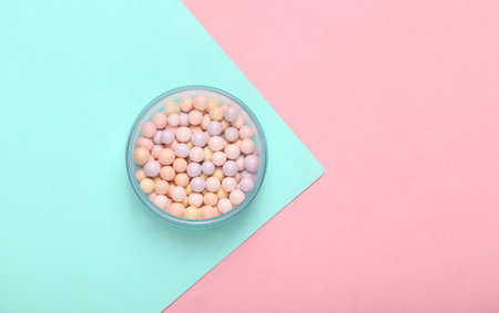 Powder Balls on pink blue background. cosmetics. top view