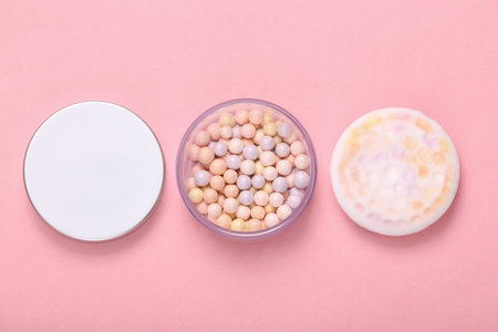 Balls of powder on pink background. cosmetics. top viewの写真素材