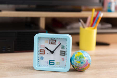 Alarm clock with globe on the computer table