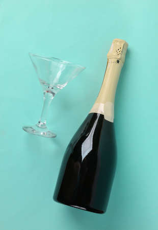 Champagne bottle and glass on blue mint backgroundの写真素材