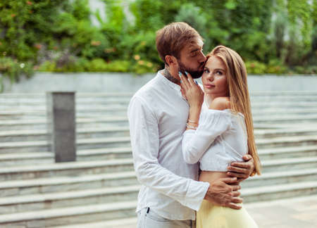 Romantic portrait of a couple in love spending time together in a city park