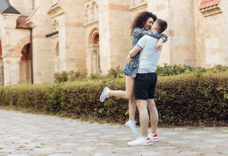 Young couple in love hug in a European city. Feeling in love, romantic conceptの写真素材