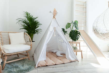 Interior of a modern children's room with a wigwam. Scandinavian style
