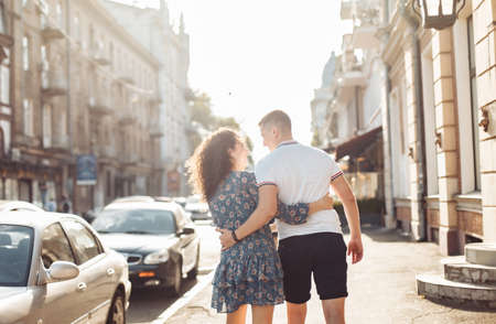 Young couple in love is walking in the city at sunset. romantic date. Falling in love concept
