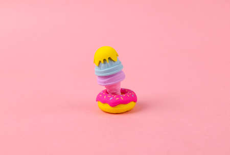 Plastic model of a donut and ice cream on pink background. minimal food conceptの写真素材
