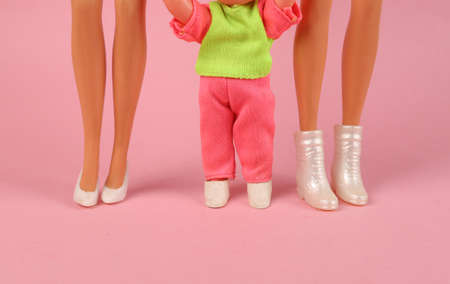 LGBT family. Two dolls mom with her little daughter on a pink background. motherhood conceptの写真素材
