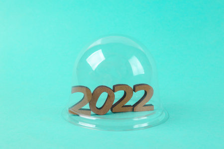 2022 under transparent dome on blue background. protection, isolation concept. minimal layout