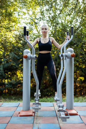 Beautiful fit woman working out on the sports ground