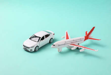 Toy car model with air plane on blue background. travel conceptの写真素材