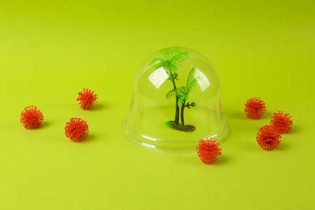 Dome with toy palm protecting against molecules of the virus strain