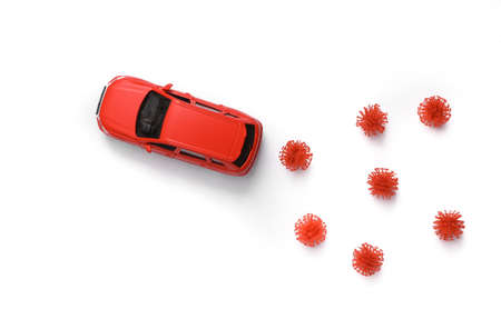 Toy car model with a virus strain on white background. Protect your health concept. top viewの写真素材