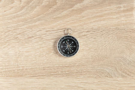 Compass on a wooden table close upの写真素材