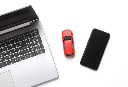 Online car search. Laptop with car and smartphone on white background. top viewの写真素材