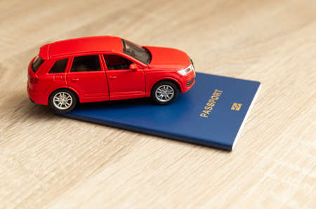 Toy model auto with charger on wooden table. electric carの写真素材