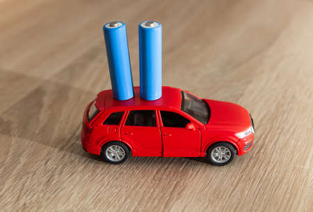 Car model with batteries on a wooden tableの写真素材