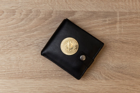 Leather wallet with bitcoin on a wooden table. business conceptの写真素材