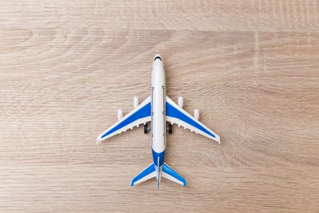 Toy model of passenger air plane on wooden table