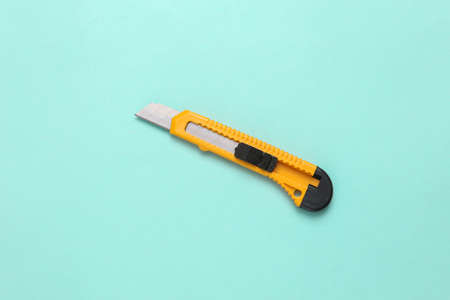 Paper knife on a blue background. top viewの写真素材