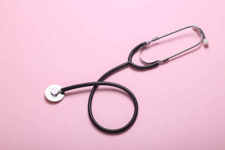 Medical stethoscope on pink background. top view. flat layの写真素材