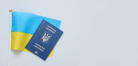 Ukrainian passport and biometric passport on a gray background. Migration, refugee status, travel concept. copy spaceの写真素材