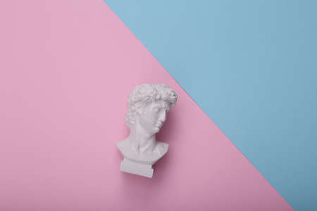 David bust on pink blue background. creative layout. Minimal still life. flat lay. top view