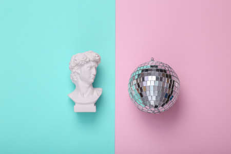 David bust with disco ball on pink blue background. creative party layout. concept pop. Minimal...