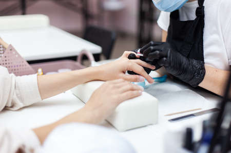 Manicurist workflow with client's nails. Nail care, manicureの写真素材