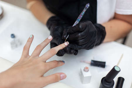 Manicurist workflow with client's nails. Nail care, manicureの写真素材