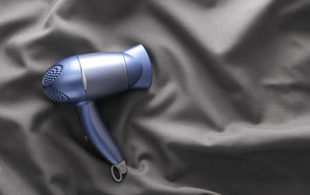 Hair dryer on gray fold silk backgroundの写真素材
