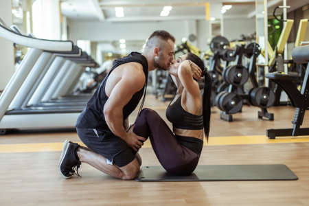 Couple in love training in the gym and kissing. healthy lifestyle. Abs workoutの写真素材