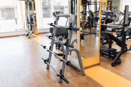 Interior of a modern gym. Rack with weights