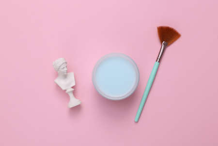 Venus bust with jar of cream on pink background. skincare conceptの写真素材