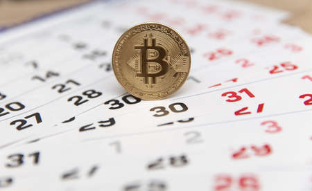 Paper Calendar with golden bitcoin.