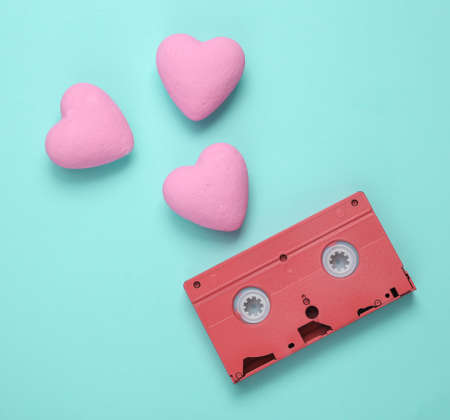 Video cassette with hearts on blue background. love concept. top viewの写真素材