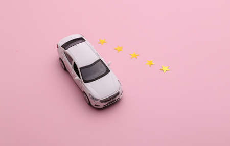 Excellent car sharing or taxi service. Car model with 5 gold stars on pink background. top view