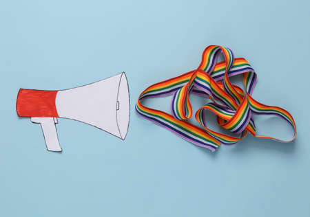 Lgbt rally, defend your rights concept, free love. Paper cut lgbt rainbow ribbon on blue backgroundの写真素材