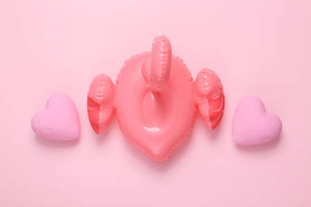 Romantic, love flat lay still life. Hearts with inflatable flamingos on a pink background. top viewの写真素材