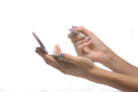 Female hands holding make-up powder box with brush isolated on white background. beauty conceptの写真素材