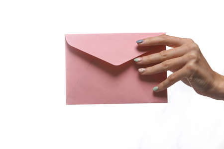 Female hand holding envelope isolated on white backgroundの写真素材