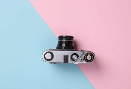 Retro camera on a blue-pink pastel background. top viewの写真素材