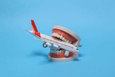 Travel, voyage concept. Jaw with airplane on blue background