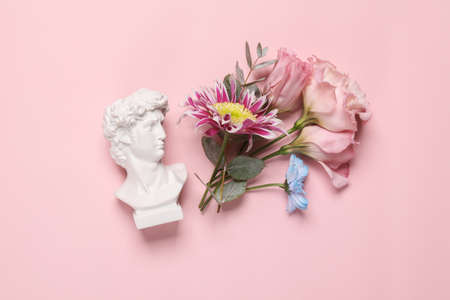 David bust with flowers on pink background. Beauty, romantic conceptの写真素材