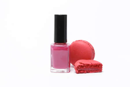Bottle of nail polish with french macaroons isolated on white backgroundの写真素材