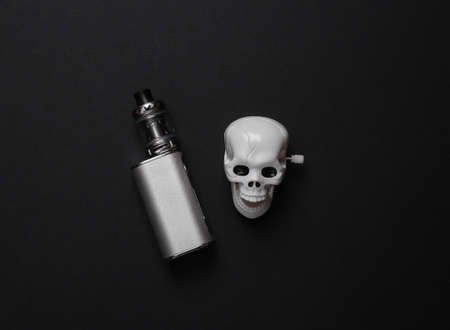 Harm smoking concept. Vaping device with a skull on a black background