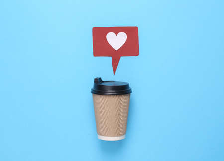 Coffee cup with like notification icon on turquoise background. social media. Rating, followers feedback. top viewの写真素材