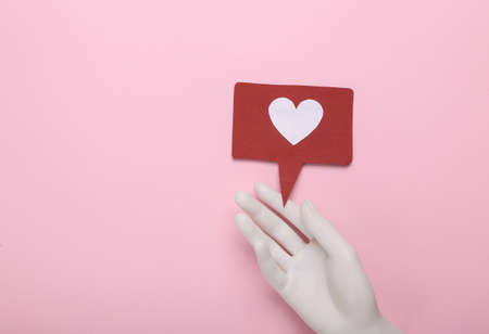 Hand with like notification icon on pink background. social media. Rating, followers feedback. top viewの写真素材