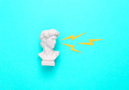 David bust with sparks from the eyes on a turquoise background. minimal concept. pop art