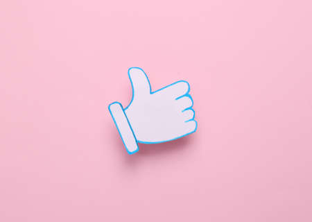 Thumbs up icons on pink background. Rating, followers feedback. top view