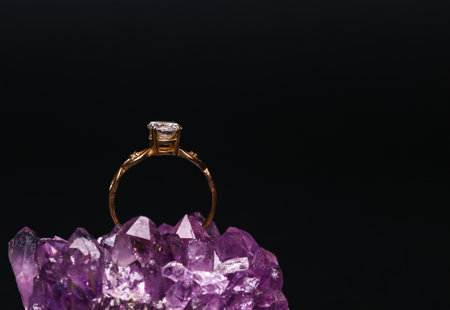 Gold ring with diamond on natural amethyst druse. isolated on black backgroundの写真素材