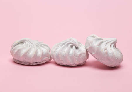 Sweet meringue on a pink background
